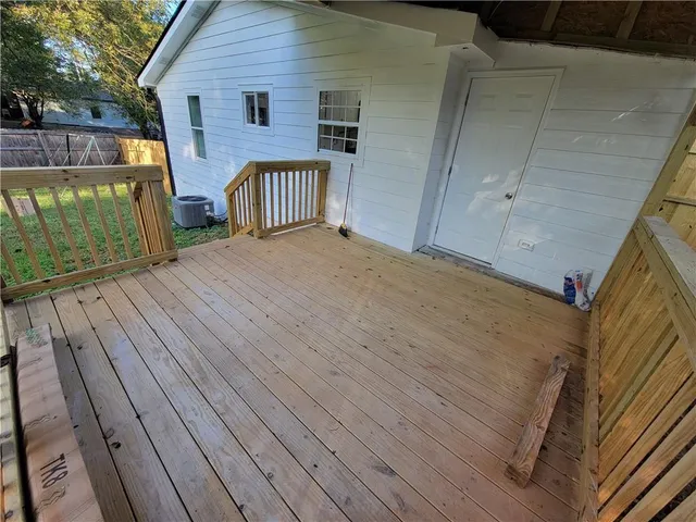 a view of backyard with a deck and wooden floor
