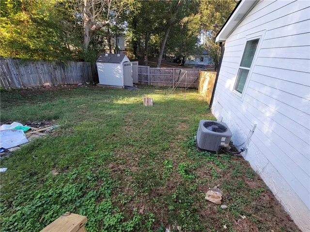 a view of a chair and table in backyard