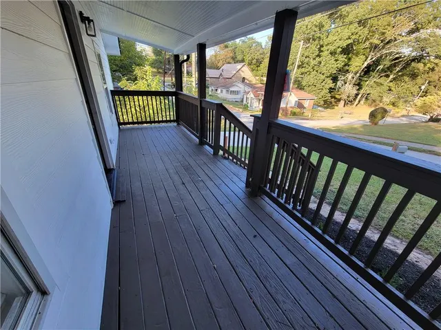 a view of a balcony with wooden floor