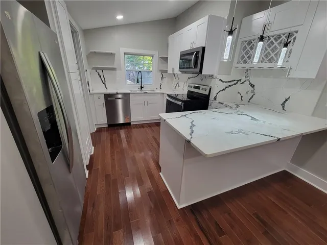 a view of kitchen and wooden floor