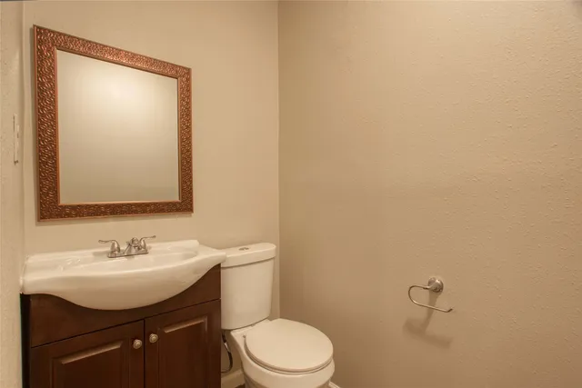 a bathroom with a sink a toilet and mirror