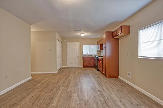 a view of a kitchen with wooden floor and electronic appliances