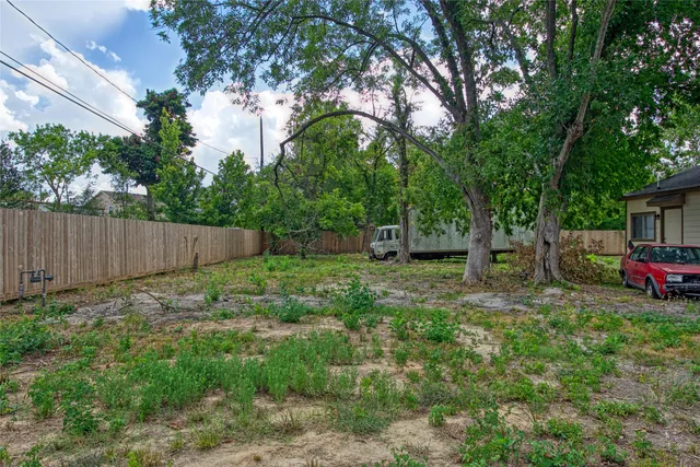 a view of a backyard with a house and large trees