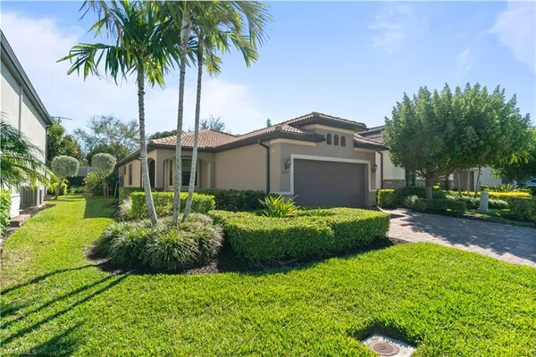 a front view of house with yard and green space
