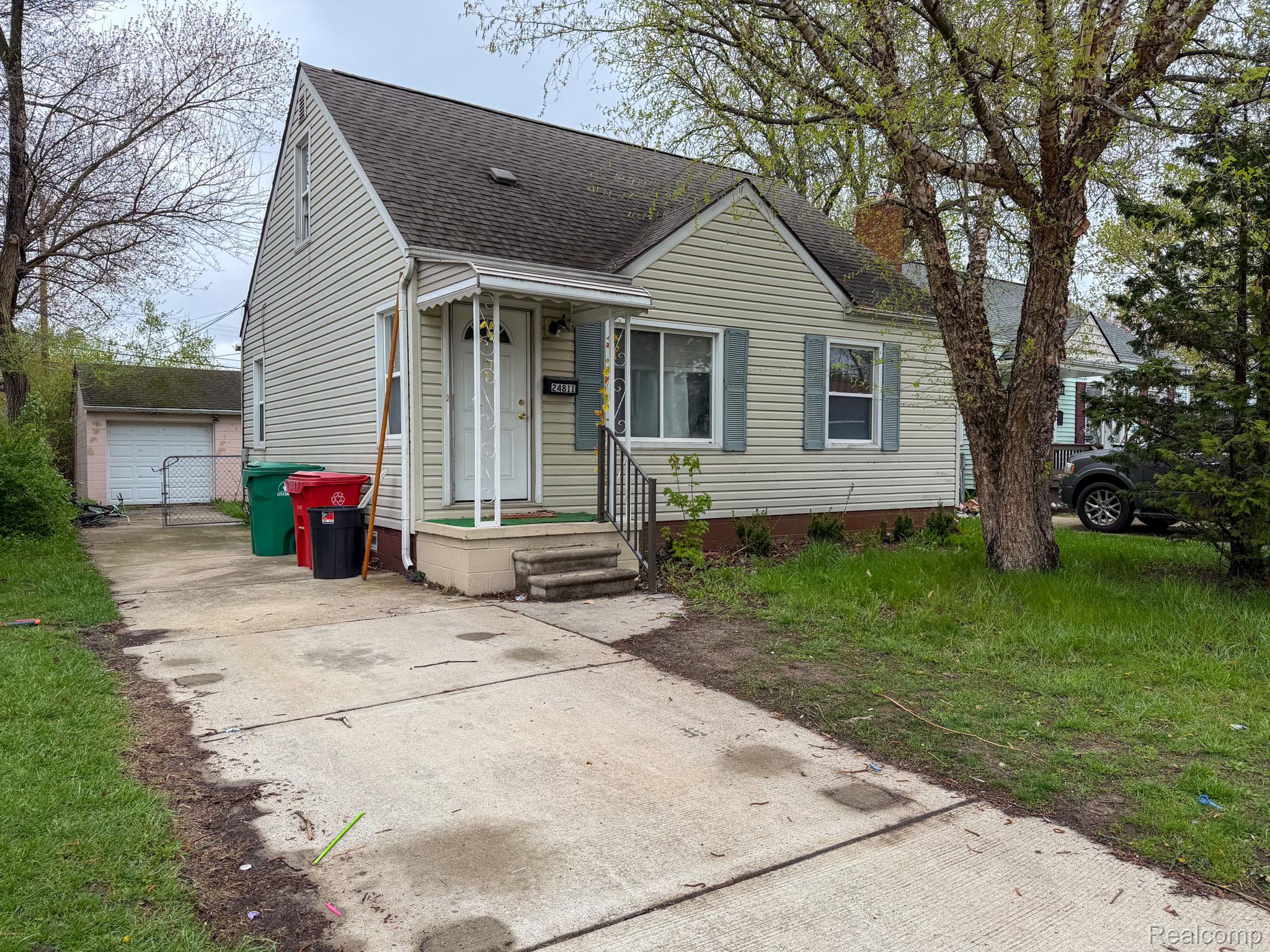 24811 Valley Avenue Eastpointe, MI 48021 - Photo 2 of 22 Bungalow with an outbuilding, a shingled roof, and a garage