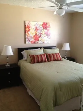 a bedroom with a bed and wall painting