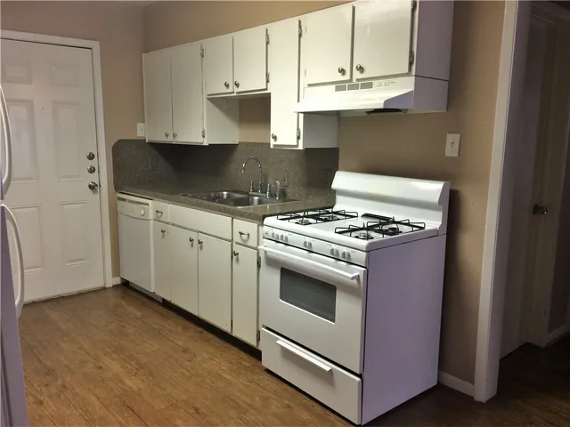 a kitchen with granite countertop cabinets and steel stainless steel appliances