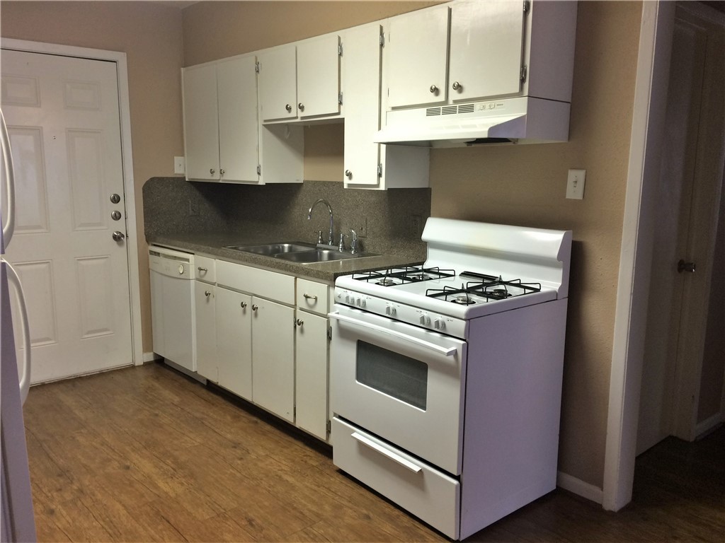 106 Hardy Street Bryan, TX 77801 - Photo 25 of 27 a kitchen with granite countertop cabinets and steel stainless steel appliances