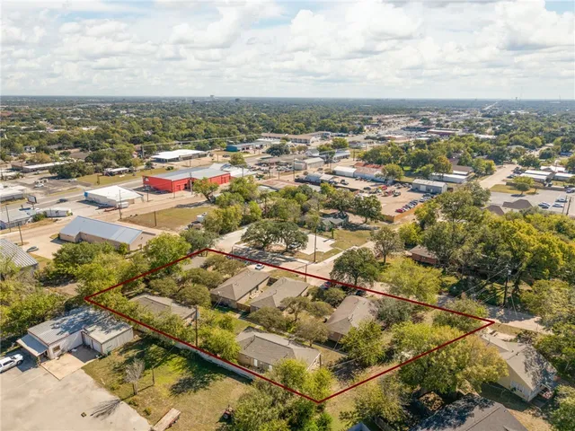 an aerial view of residential houses with city view