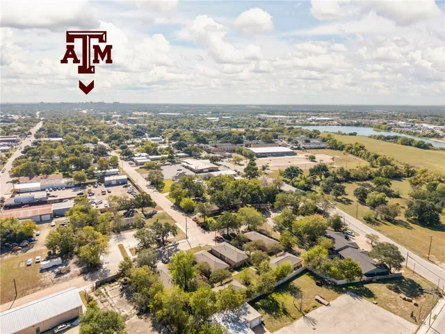 an aerial view of residential building with yard
