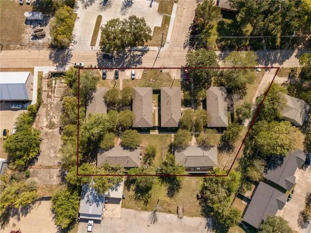 an aerial view of residential houses with outdoor space