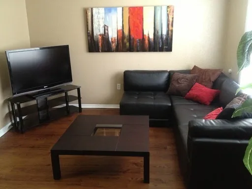 a living room with furniture and a flat screen tv