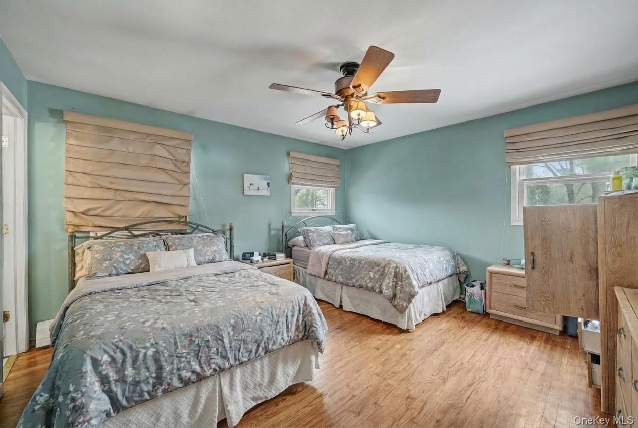 6 Kakiat Lane Spring Valley, NY 10977 - Photo 12 of 25 a bedroom with two beds and a chandelier