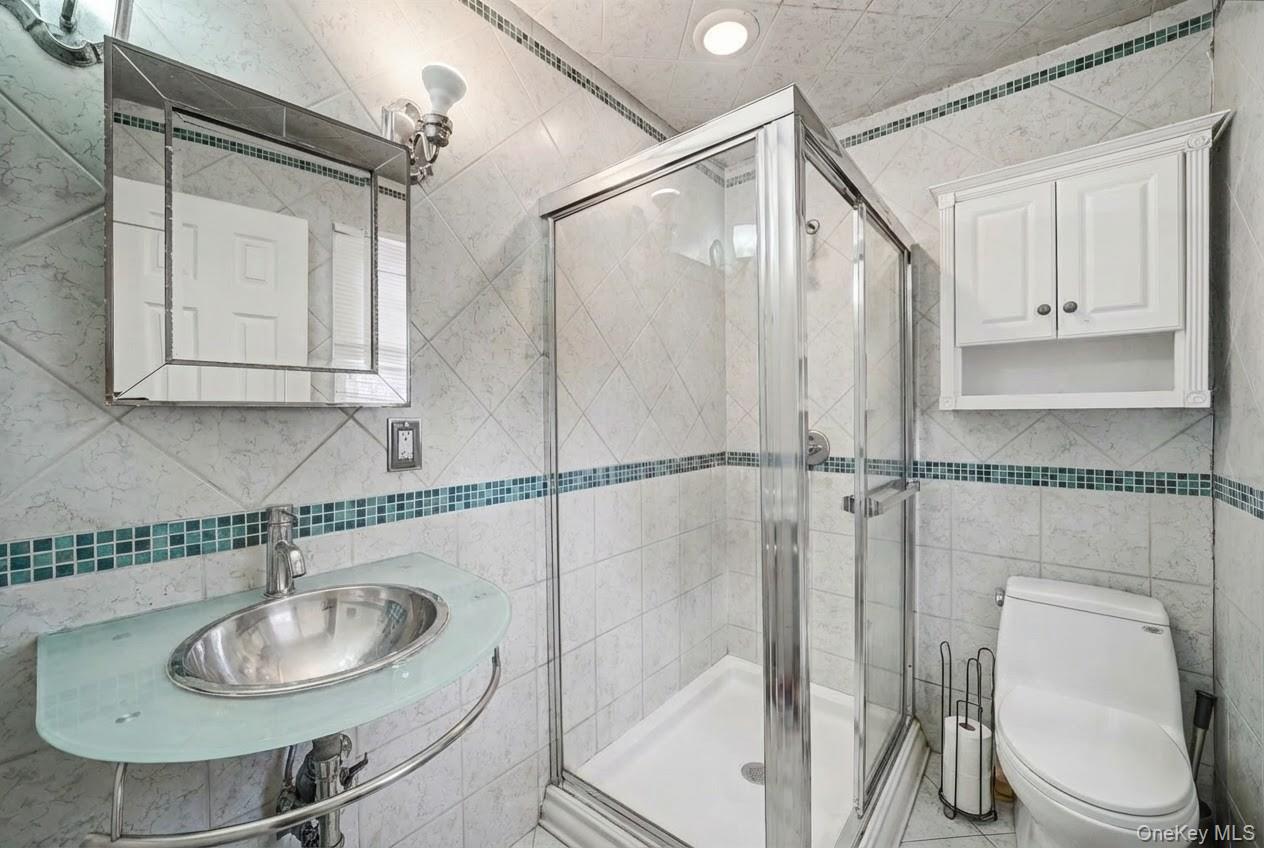 6 Kakiat Lane Spring Valley, NY 10977 - Photo 14 of 25 a bathroom with a sink toilet and shower