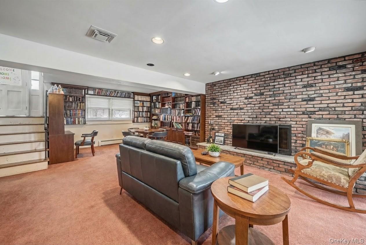6 Kakiat Lane Spring Valley, NY 10977 - Photo 20 of 25 a living room with furniture and a fireplace
