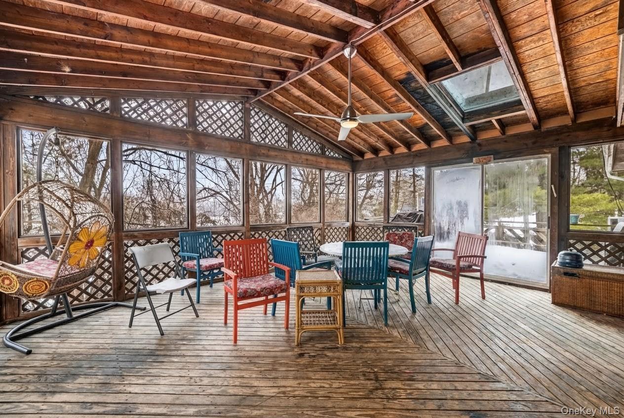 6 Kakiat Lane Spring Valley, NY 10977 - Photo 22 of 25 a dining room with furniture a floor to ceiling window and wooden floor