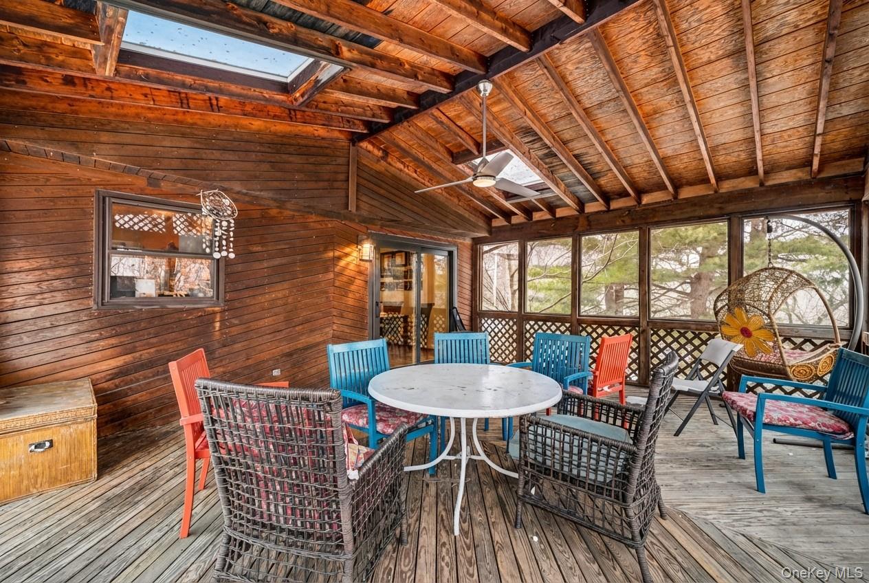 6 Kakiat Lane Spring Valley, NY 10977 - Photo 23 of 25 a view of a patio with table and chairs with wooden floor and fence