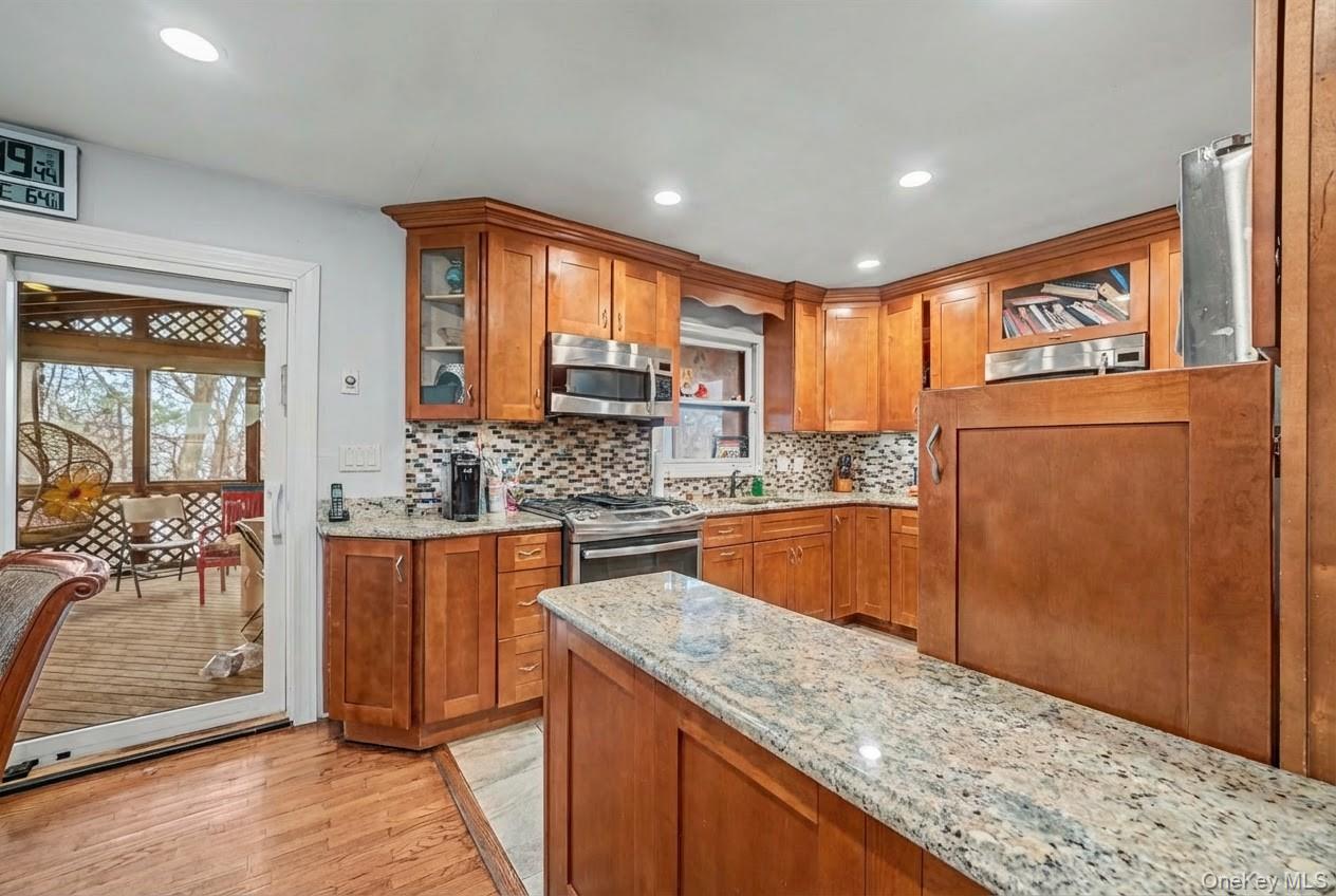 6 Kakiat Lane Spring Valley, NY 10977 - Photo 8 of 25 a kitchen with stainless steel appliances granite countertop wooden cabinets and a counter top space