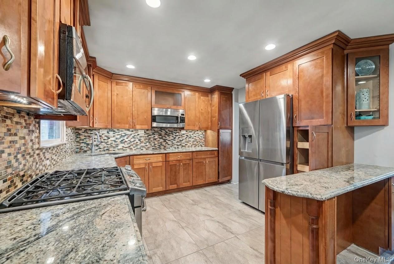 6 Kakiat Lane Spring Valley, NY 10977 - Photo 9 of 25 a kitchen with stainless steel appliances granite countertop a refrigerator and a stove top oven