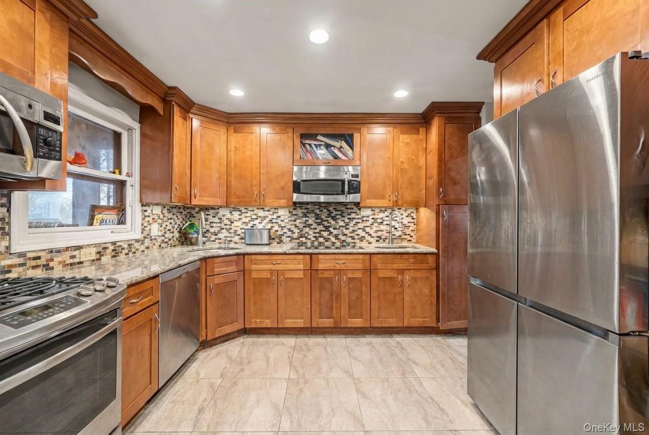 6 Kakiat Lane Spring Valley, NY 10977 - Photo 10 of 25 a large kitchen with stainless steel appliances granite countertop a refrigerator and a sink