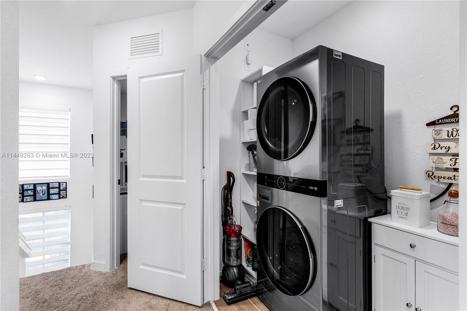 781 Southeast 19th Street Homestead, FL 33034 - Photo 21 of 41 a utility room with dryer washer and a view of bedroom