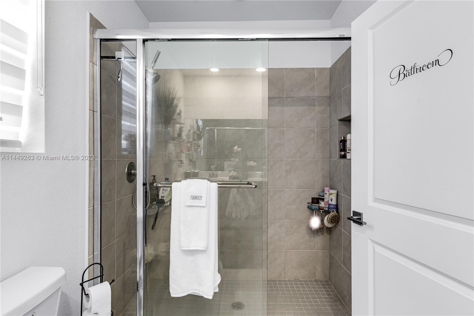 781 Southeast 19th Street Homestead, FL 33034 - Photo 32 of 41 a bathroom with a glass shower door