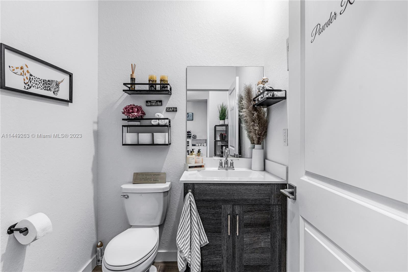 781 Southeast 19th Street Homestead, FL 33034 - Photo 35 of 41 a bathroom with a sink a toilet and a mirror