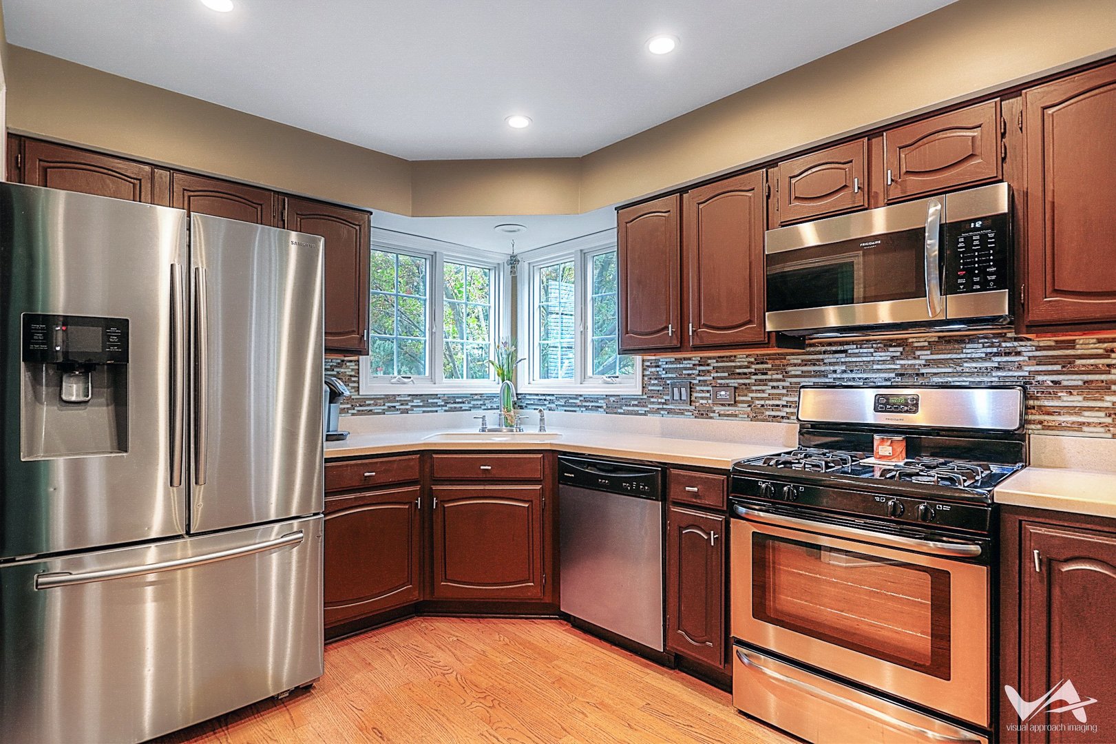 809 Arrowhead Lane St. Charles, IL 60174 - Photo 11 of 38 a kitchen with stainless steel appliances granite countertop a stove top oven a sink and a refrigerator