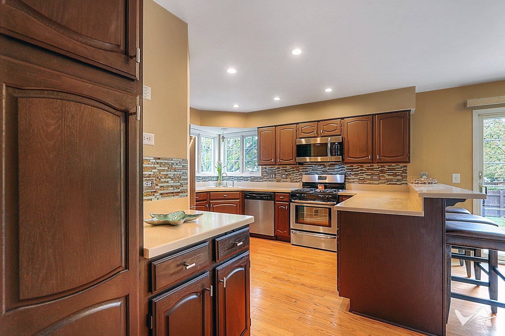 809 Arrowhead Lane St. Charles, IL 60174 - Photo 12 of 38 a kitchen with stainless steel appliances granite countertop a refrigerator stove microwave and sink