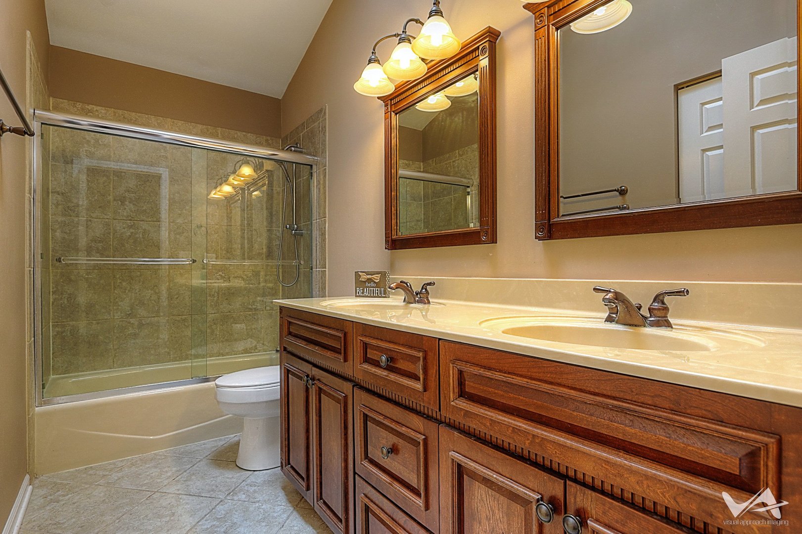 809 Arrowhead Lane St. Charles, IL 60174 - Photo 25 of 38 a bathroom with a granite countertop sink toilet mirror vanity and bathtub