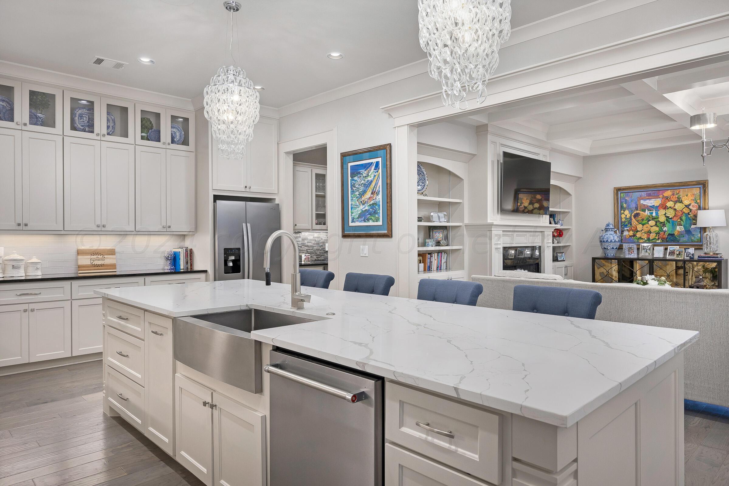 8307 Georgetown Drive Amarillo, TX 79119 - Photo 11 of 46 a kitchen that has a lot of cabinets in it and wooden floors