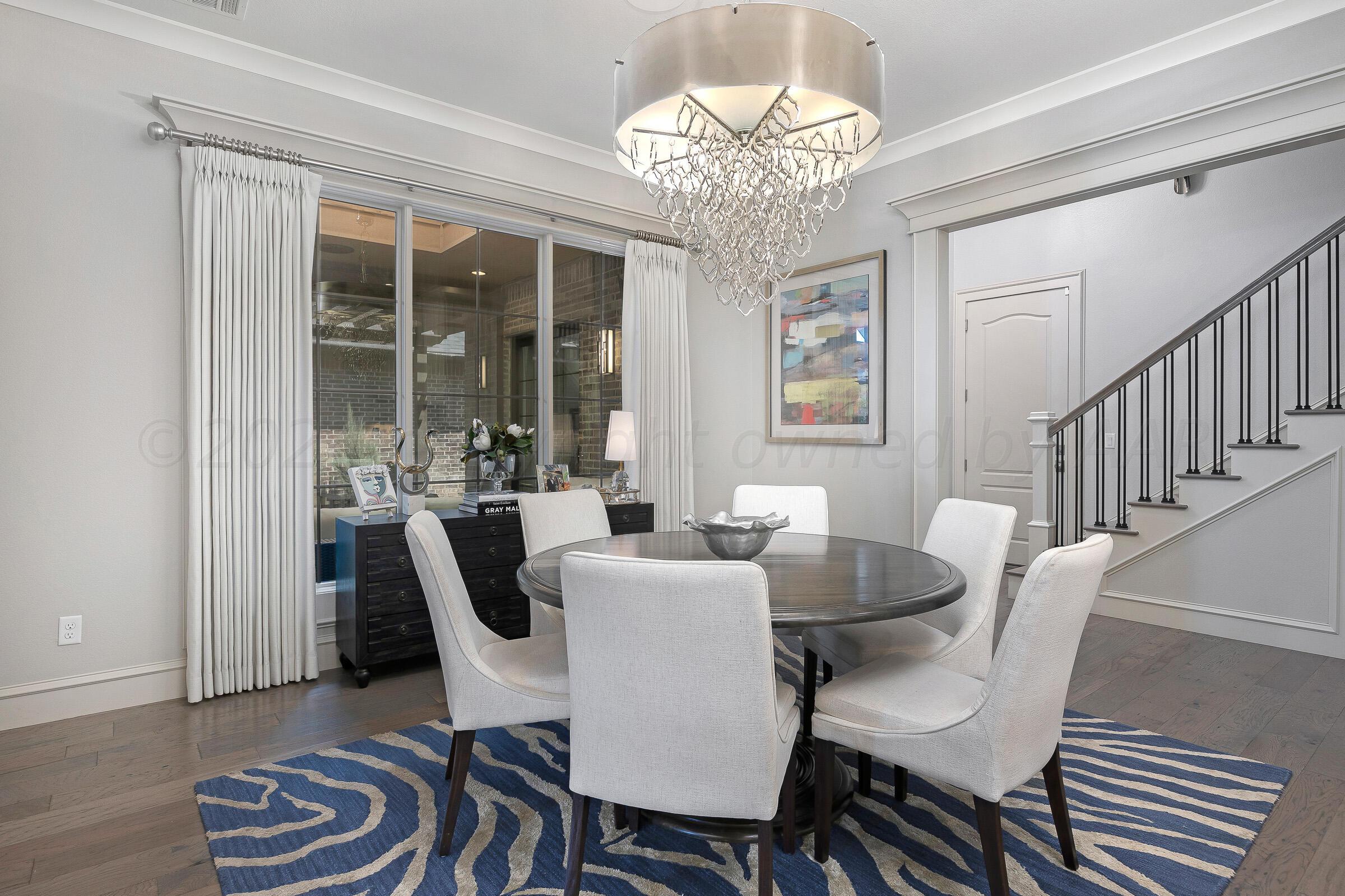 8307 Georgetown Drive Amarillo, TX 79119 - Photo 15 of 46 a view of a dining room with furniture wooden floor and chandelier