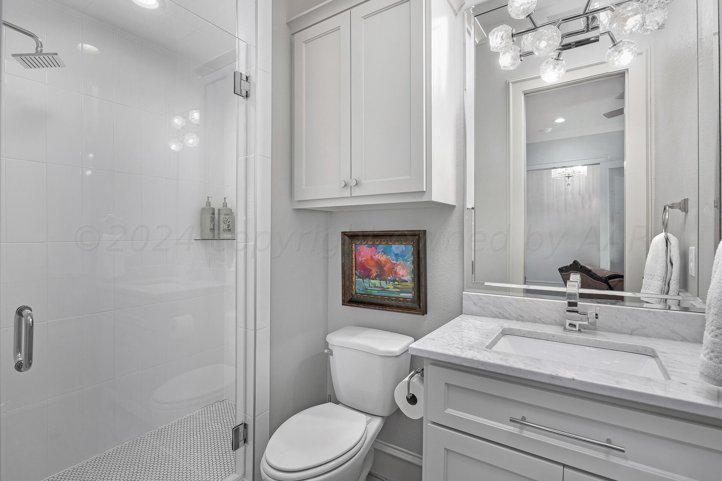 8307 Georgetown Drive Amarillo, TX 79119 - Photo 24 of 46 a bathroom with a sink a toilet and shower