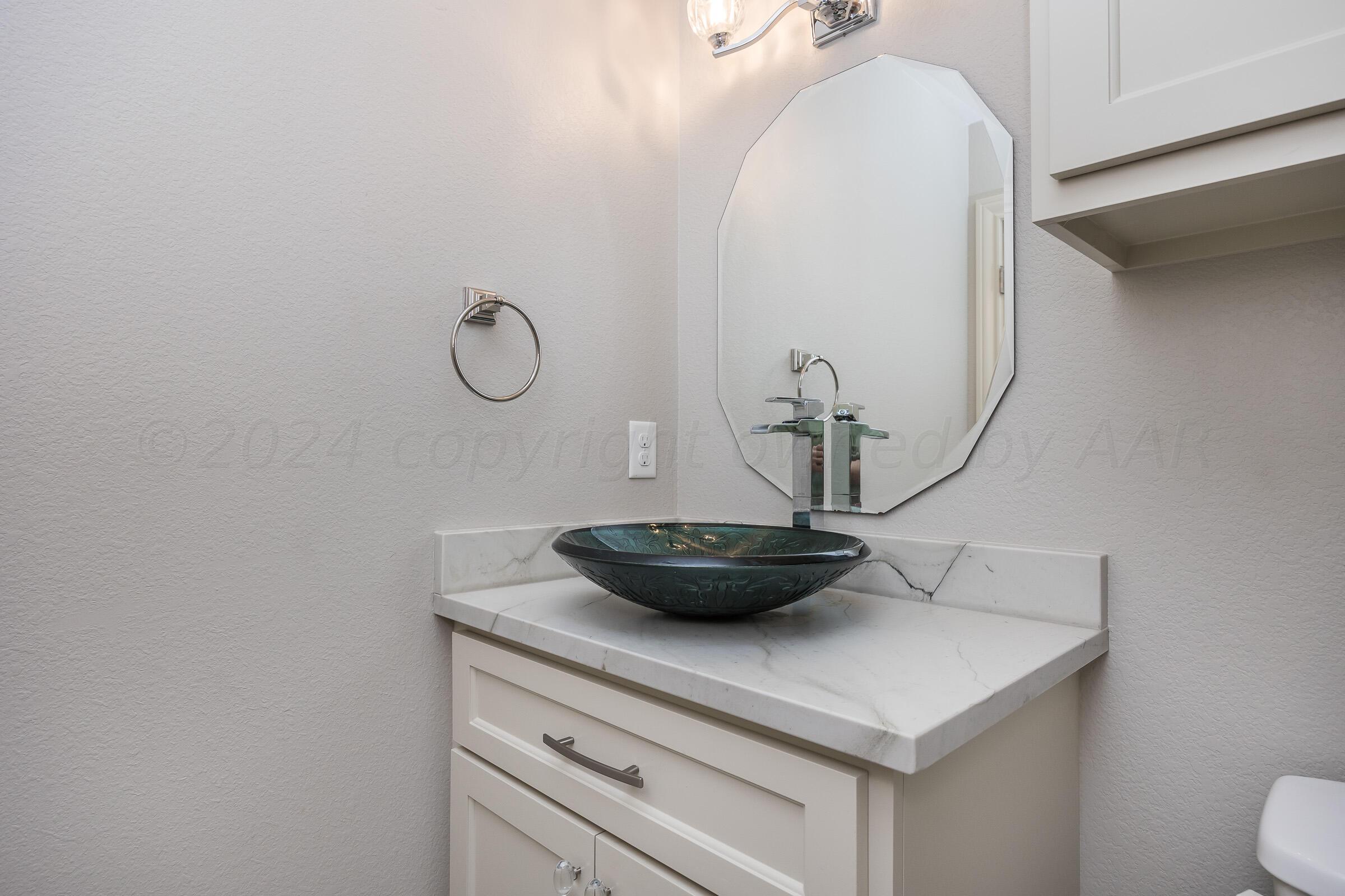 8307 Georgetown Drive Amarillo, TX 79119 - Photo 31 of 46 a bathroom with a sink and a mirror