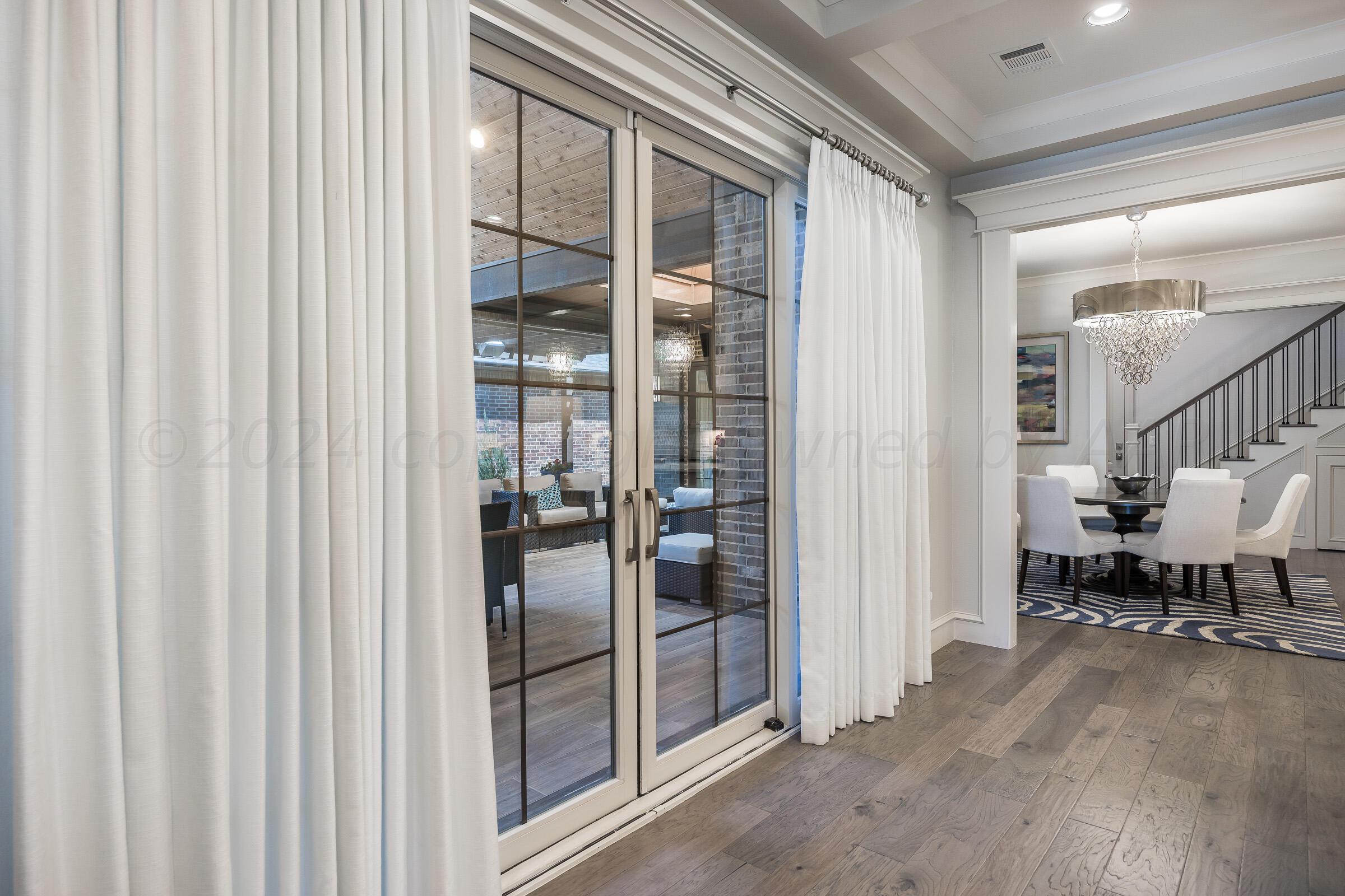8307 Georgetown Drive Amarillo, TX 79119 - Photo 36 of 46 a view of a hallway with dining room and wooden floor