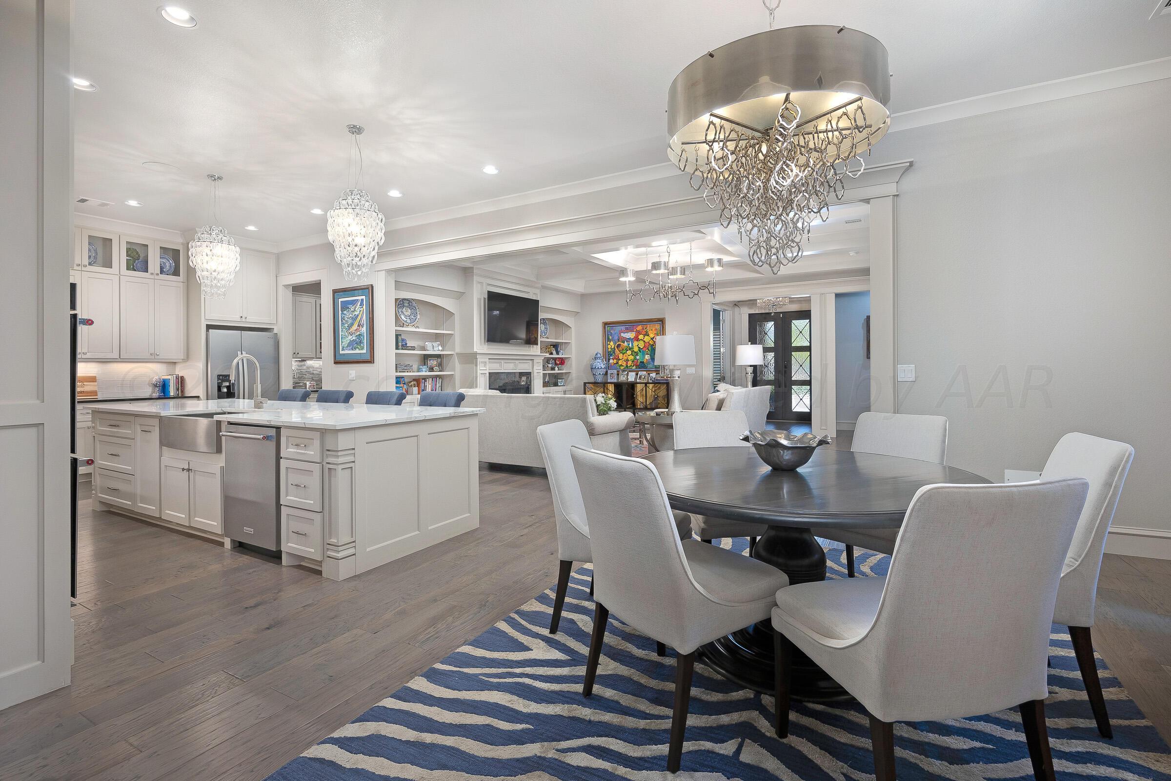 8307 Georgetown Drive Amarillo, TX 79119 - Photo 4 of 46 a dining room filled chandelier and white furniture