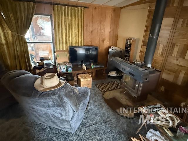 2934 East Little Basin Road King Hill, ID 83633 - Photo 15 of 29 Sitting room with wooden walls and a wood stove