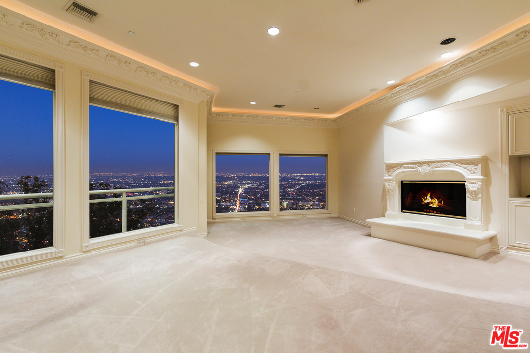 8570 Cole Crest Drive Los Angeles, CA 90046 - Photo 12 of 28 a view of an empty room with a fireplace and a window