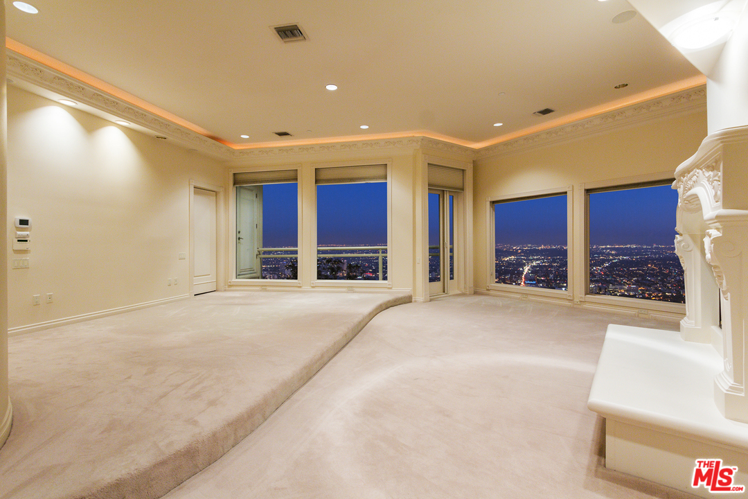 8570 Cole Crest Drive Los Angeles, CA 90046 - Photo 13 of 28 a view of a hallway with a furniture and a large window