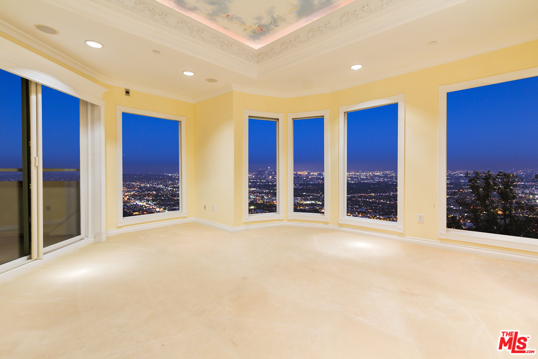 8570 Cole Crest Drive Los Angeles, CA 90046 - Photo 18 of 28 a view of an empty room with a balcony and window