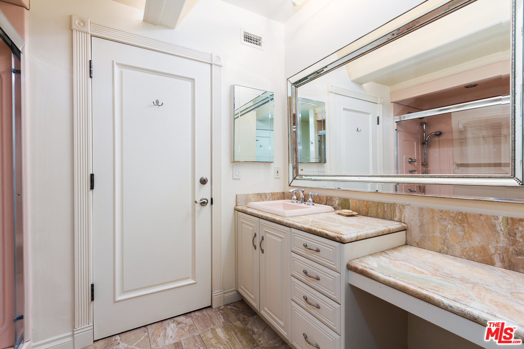 8570 Cole Crest Drive Los Angeles, CA 90046 - Photo 22 of 28 a bathroom with a sink and a mirror