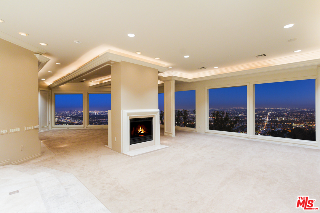 8570 Cole Crest Drive Los Angeles, CA 90046 - Photo 9 of 28 a view of a livingroom with a fireplace and cabinet