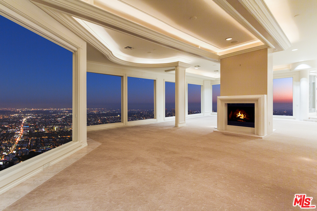 8570 Cole Crest Drive Los Angeles, CA 90046 - Photo 10 of 28 a view of an empty room with a fireplace and a window