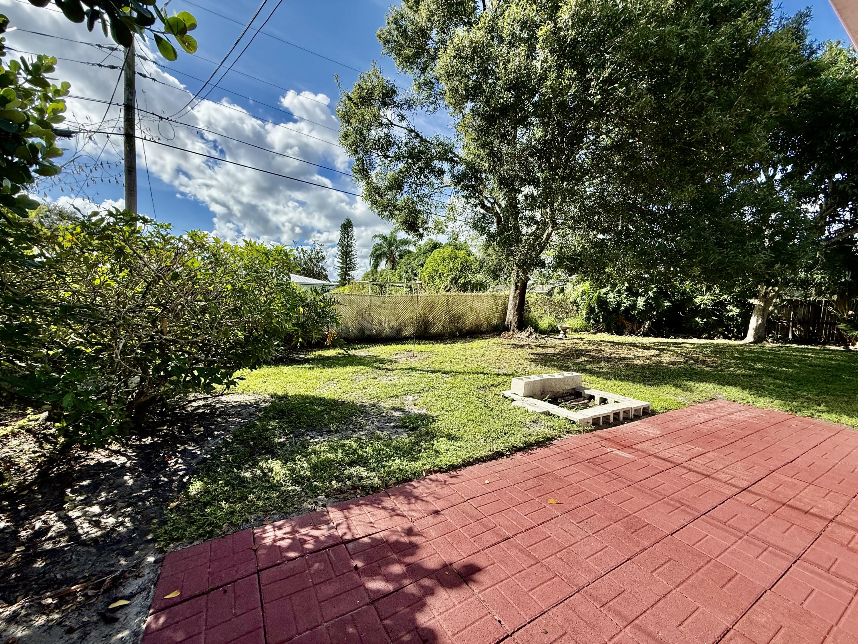 612 Coconut Avenue North Port St. Lucie, FL 34952 - Photo 11 of 32 a view of a yard with plants