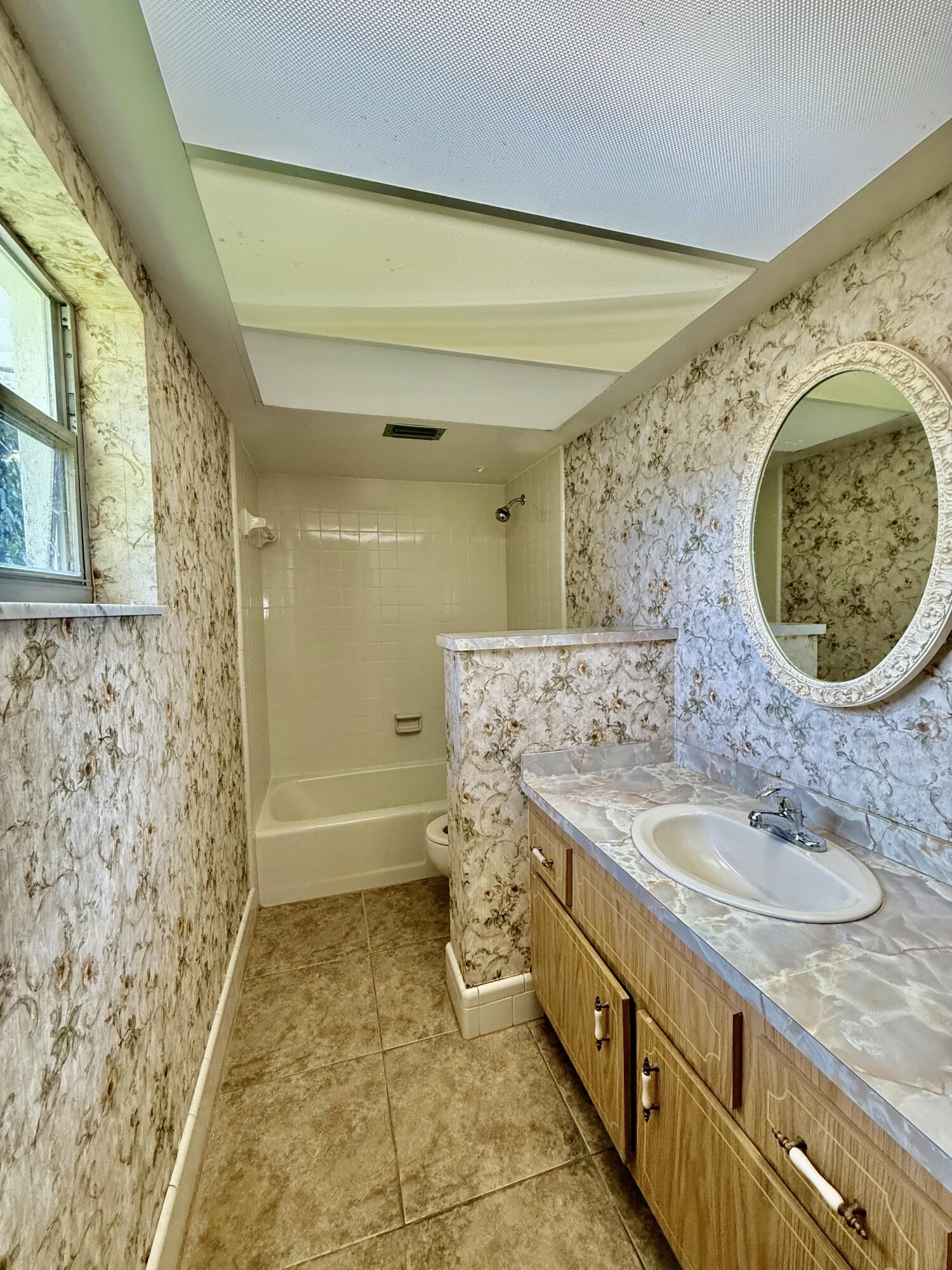 612 Coconut Avenue North Port St. Lucie, FL 34952 - Photo 14 of 32 a spacious bathroom with a granite countertop sink and a mirror