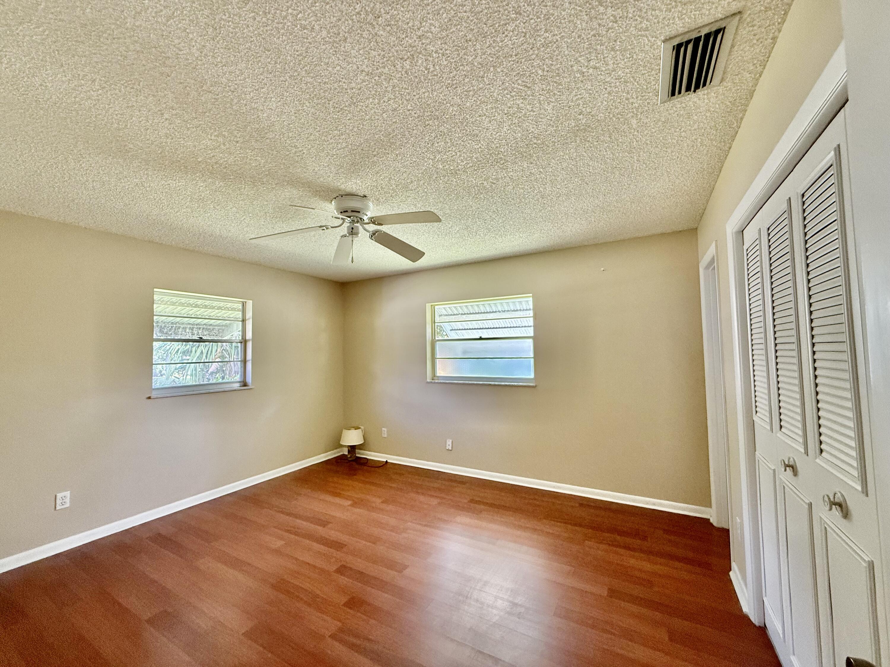 612 Coconut Avenue North Port St. Lucie, FL 34952 - Photo 15 of 32 wooden floor in an empty room with a window