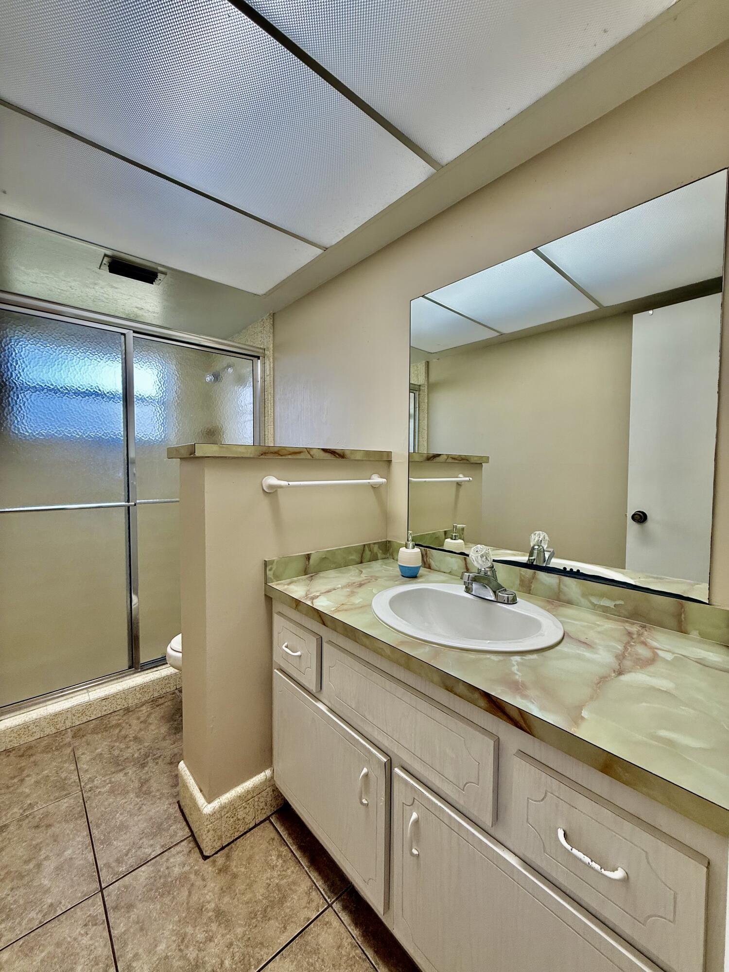 612 Coconut Avenue North Port St. Lucie, FL 34952 - Photo 17 of 32 a bathroom with a sink and mirror