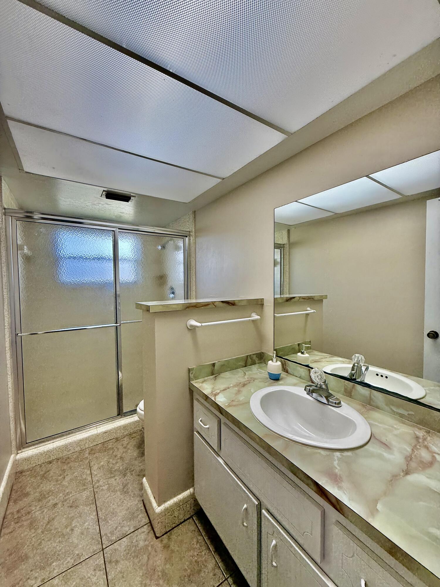 612 Coconut Avenue North Port St. Lucie, FL 34952 - Photo 20 of 32 a bathroom with a sink and a mirror