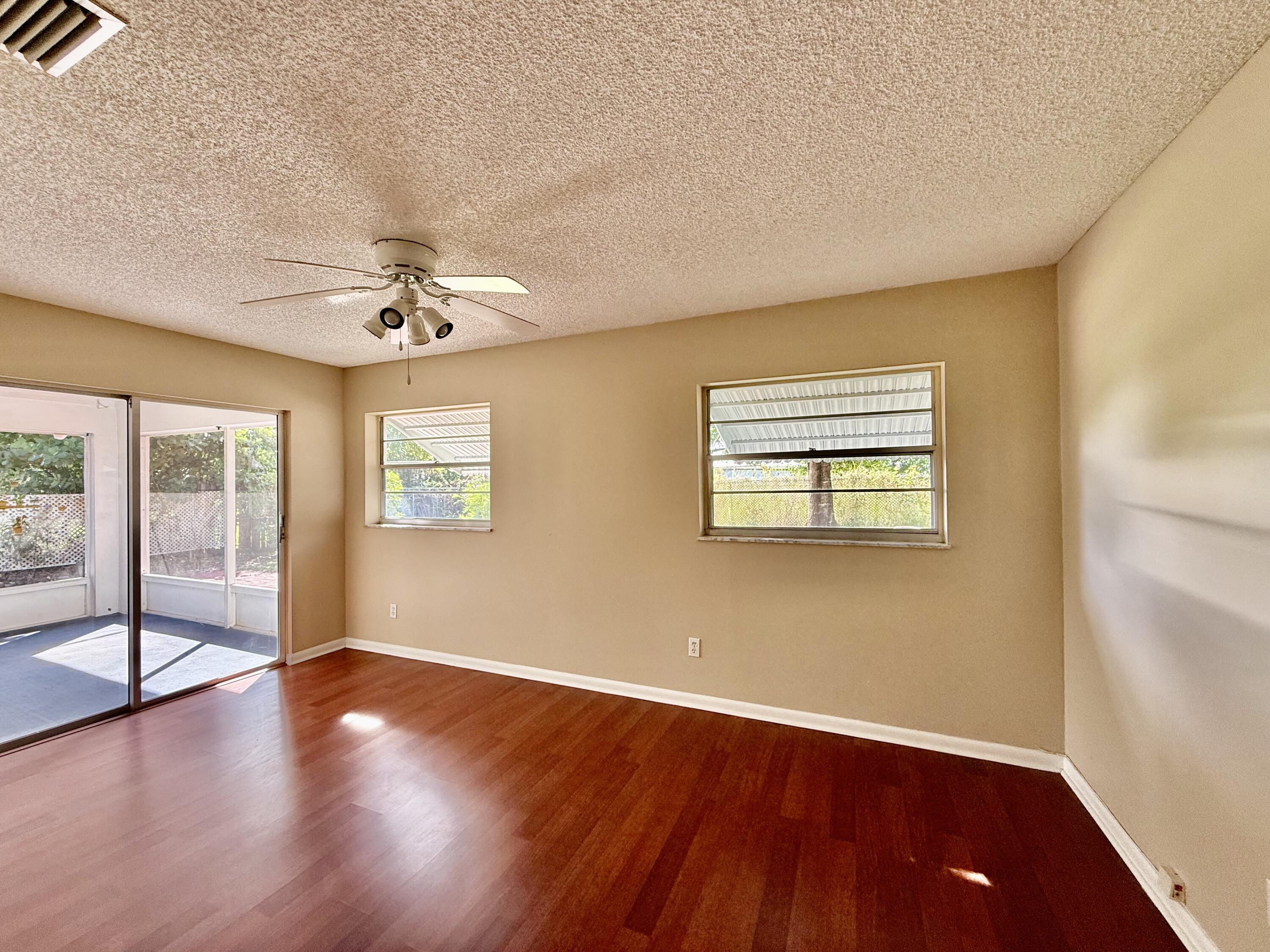 612 Coconut Avenue North Port St. Lucie, FL 34952 - Photo 21 of 32 a view of an empty room with wooden floor and a window