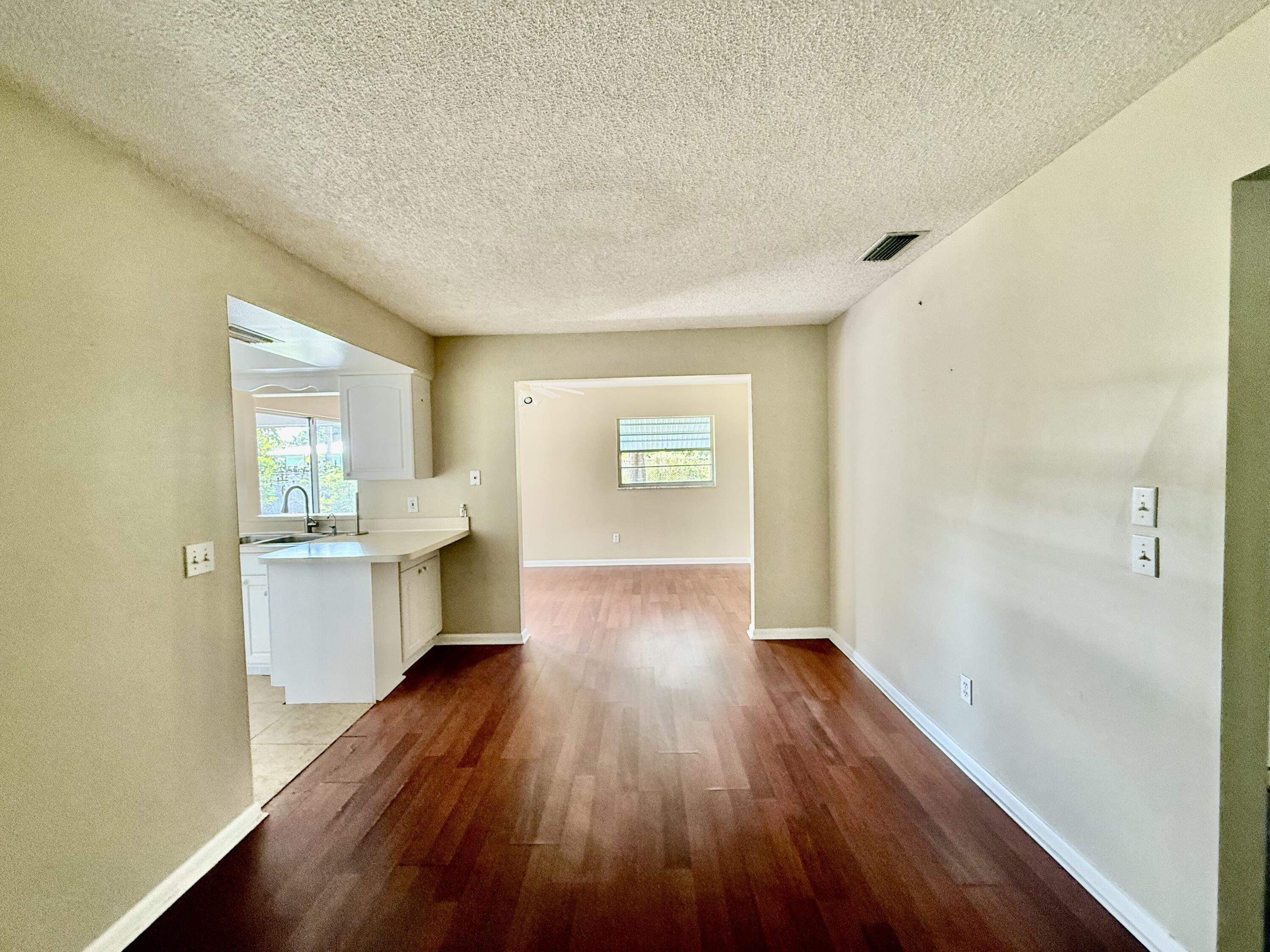612 Coconut Avenue North Port St. Lucie, FL 34952 - Photo 26 of 32 a view of a kitchen with wooden floor and a sink